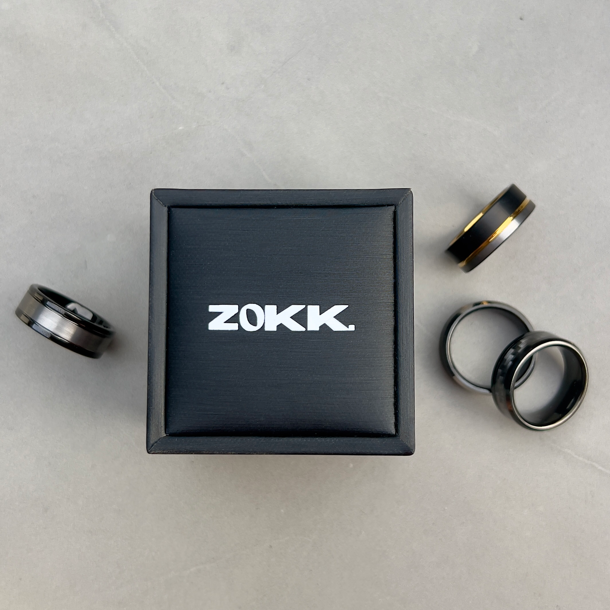 ZOKK ring box surrounded by tungsten rings